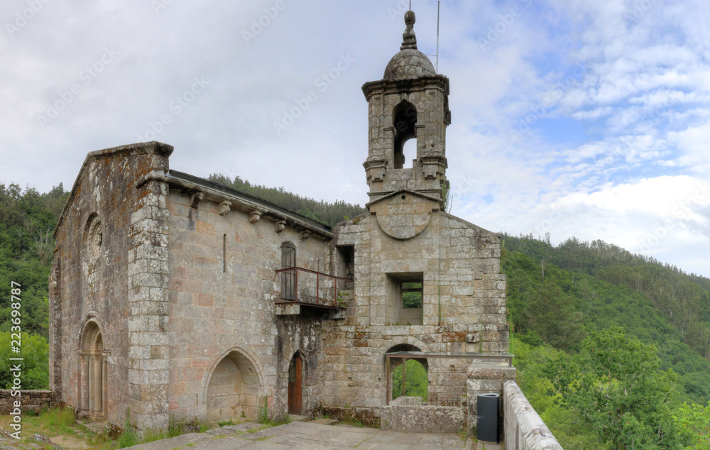 The ancient, stone-made, lost Caaveiro Monastery (Monasterio de Caaveiro) in the Fragas del Eume green and thick forest in Galicia, Spain