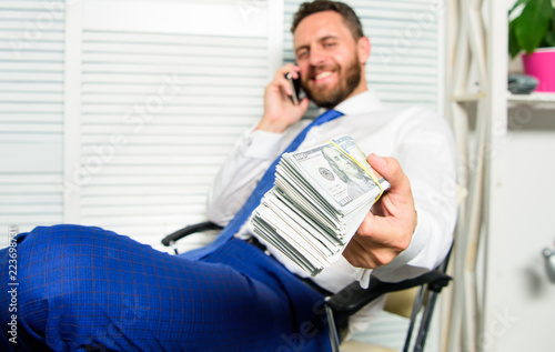 Get cash in few minutes. Banking support line concept. Man successful businessman phone conversation ask service. Businessman rich bearded guy sit office with lot of cash money. Bank loan or credit