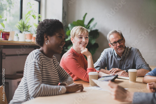 Group of coworkers having a meeting in a cafe