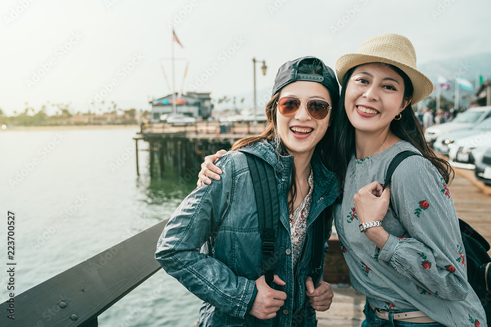 friends laughing happily while visiting a wharf