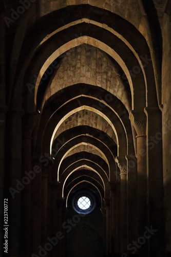 A series of horseshoe moorish arches in backlight and a window in the Veruela Cistercian abbey, in Aragon region, Spain