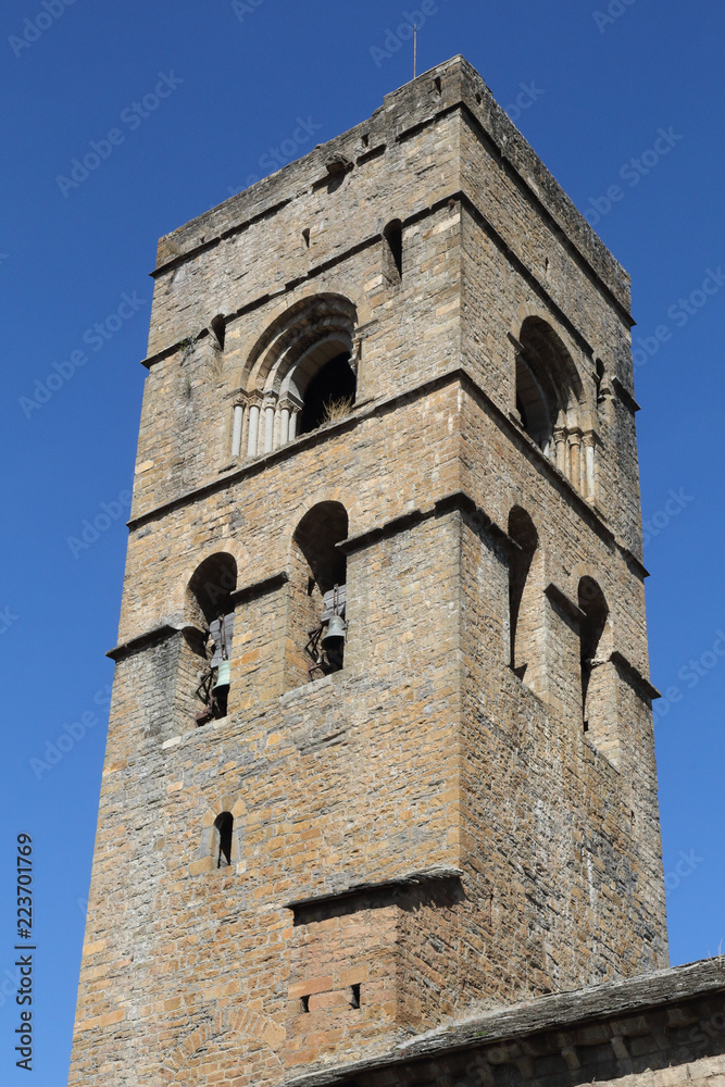 The stone bell tower of the romaneque Holy Mary Church (Iglesia de Santa Maria) in Ainsa, a small rural village in the Spanish Aragonese Pyrenees mountains