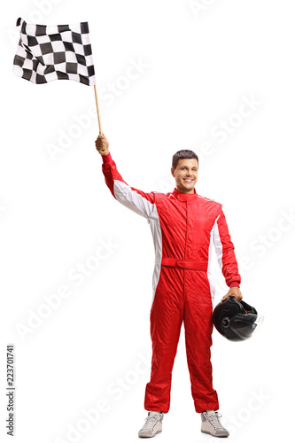 Racer holding a checkered flag and a helmet