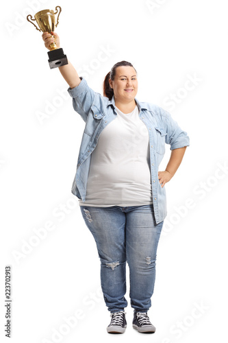 Overweight woman holding a gold trophy cup photo