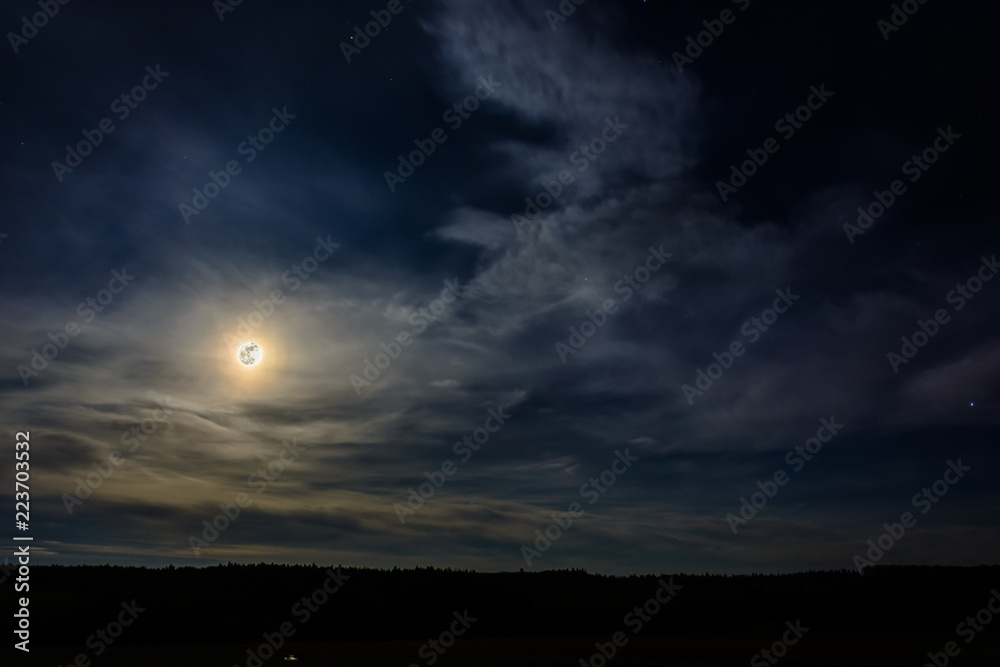 A wonderful full moon has descended over Ukrainian carpathians in blurry clouds A wonderful full moon has descended over Ukrainian carpathians in blurry clouds