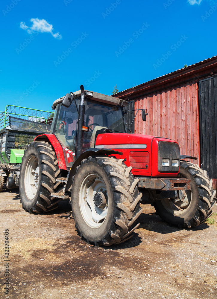 Tractor with a trailer for hay on the farm. Tractor with a trailer for hay on the farm.