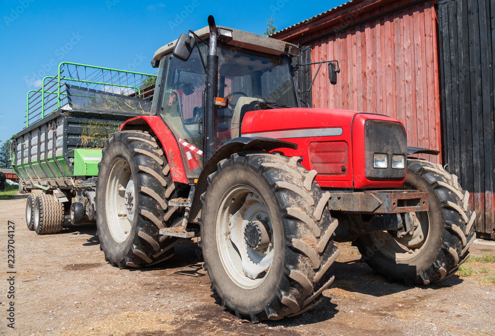 Tractor with a trailer for hay on the farm. Tractor with a trailer for hay on the farm.