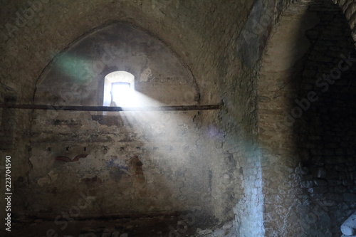 A light beam lighting the darkness of the the empty church of Janovas, a ruined village in the Aragonese Pyrenees abandoned during the sixties due to the building of a dam