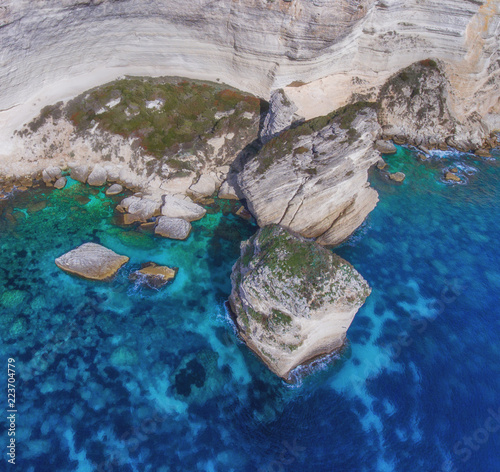 Giant boulders in the sea break away from the limestone coast.