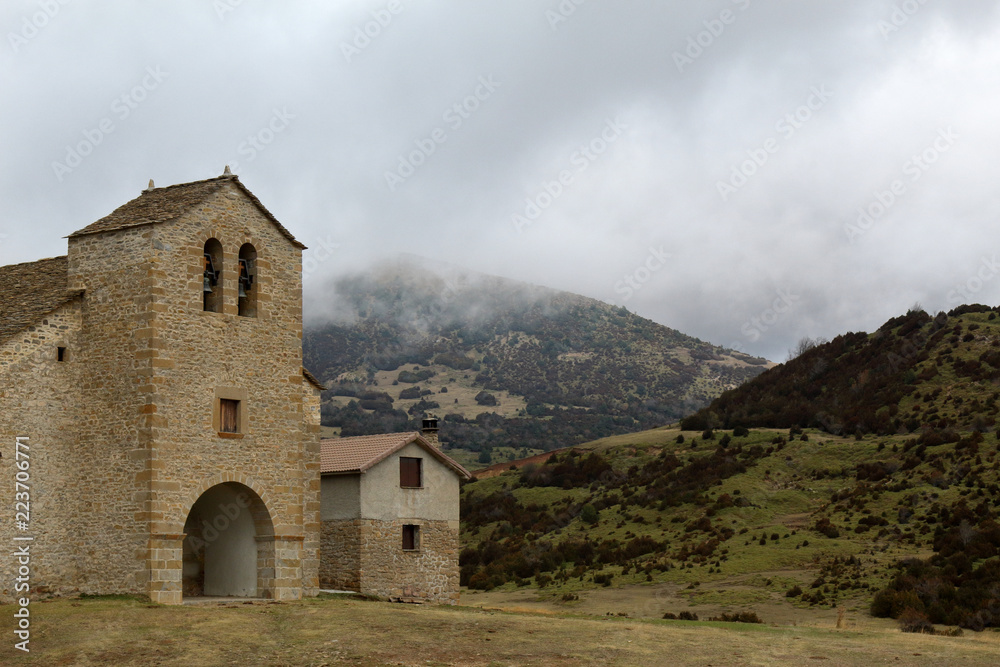The Santa Orosia sanctuary in the foggy and cloudy mountains next to Yebra de Basa small town in the Aragonese Pyrenees, Spain
