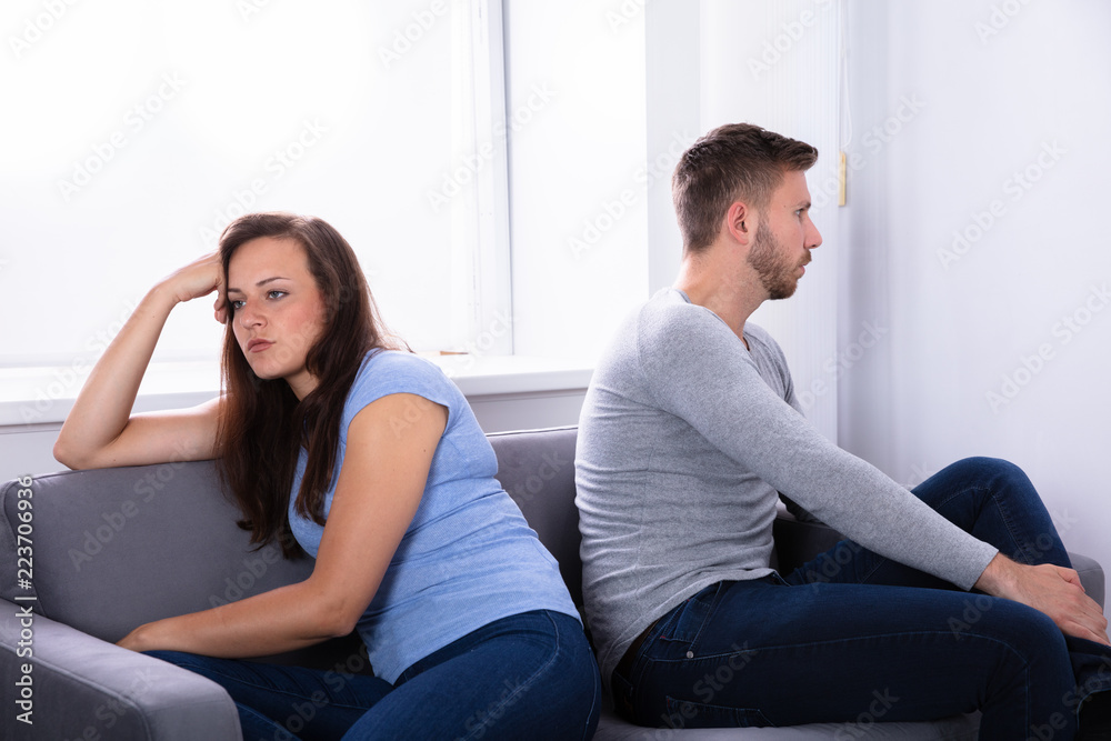 Obraz premium Upset Couple Sitting On Sofa