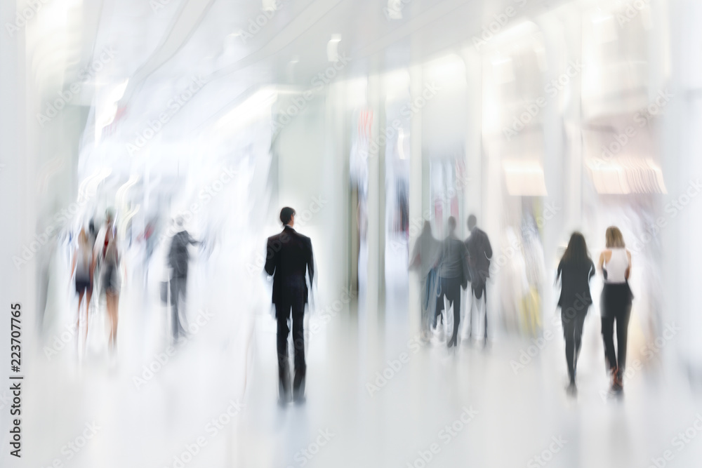 abstract image of people in the lobby of a modern business center with a blurred background