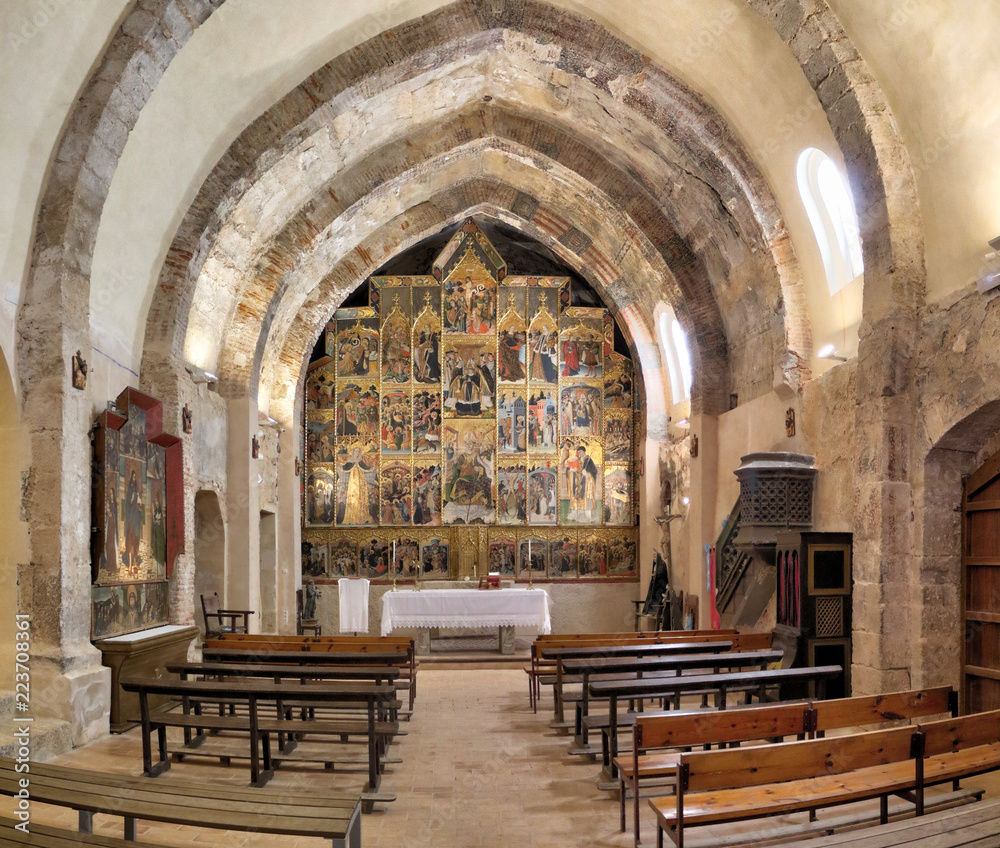 The single nave church Saint Blaise Church (Iglesia de San Blas), with a perfectly conservated retable gothic paintings behind the altar, in the Anento small town, in Aragon province, Spain