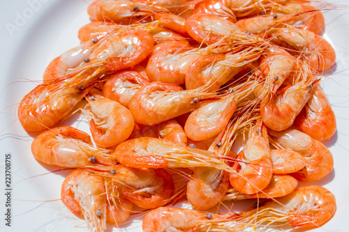 boiled red shrimps on wooden tray, seafood background