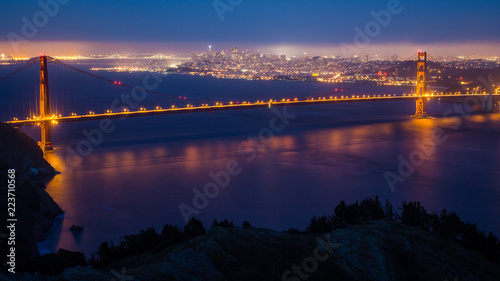 The Golden Gate Bridge at night with San Francisco in the distance