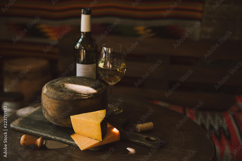 delicious cheese with white wine on rustic wooden table