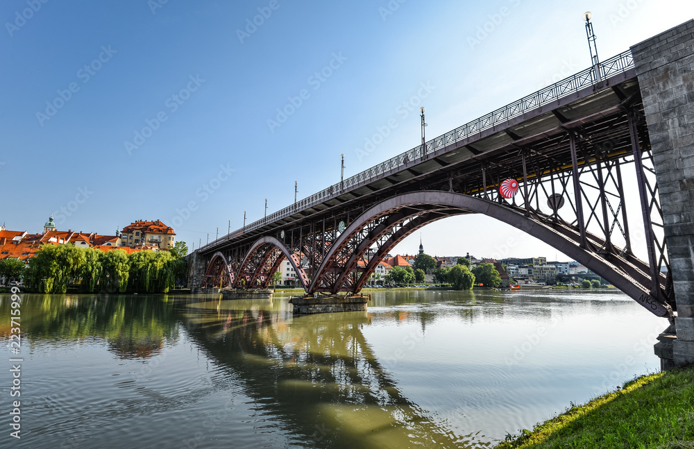 Drava river, sky reflection and bridge. The Main Bridge across Drava river in Maribor, Slovenia