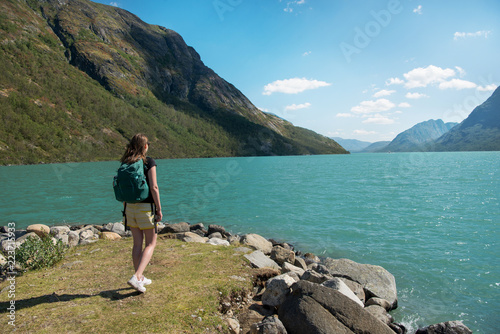 traveler looking at Gjende lake in Jotunheimen National Park, Norway
