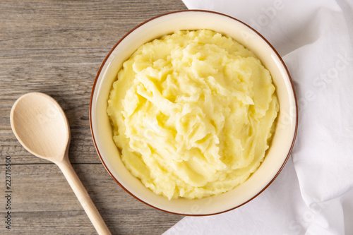 Puree from potatoes in a plate. Wooden background. Top Vieux. Macro.