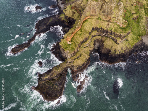Causeway Coast near Giant's Causeway without tourists aerial view of waves and basalt rocks. © Gheorghe
