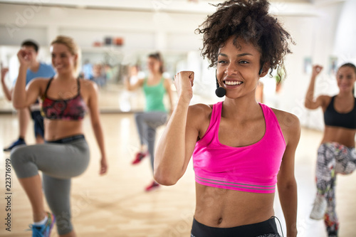 Female instructor with headset in fitness class