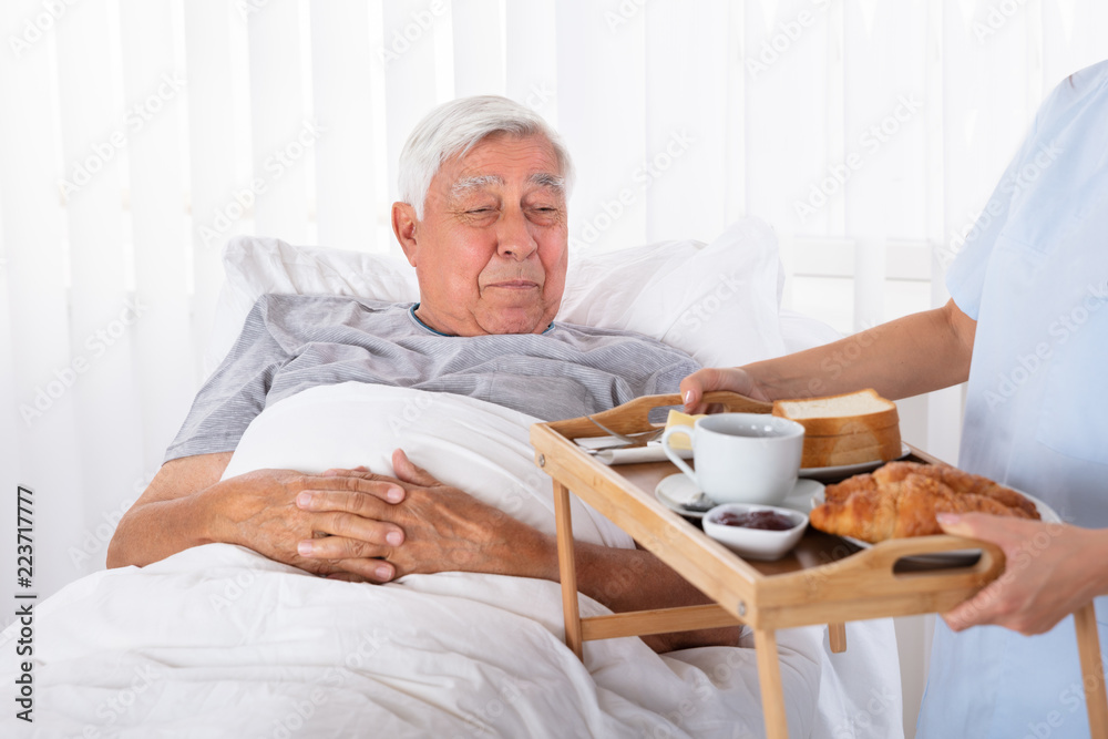 Nurse Serving Food To Senior Patient Nurse Serving Food To Senior Patient