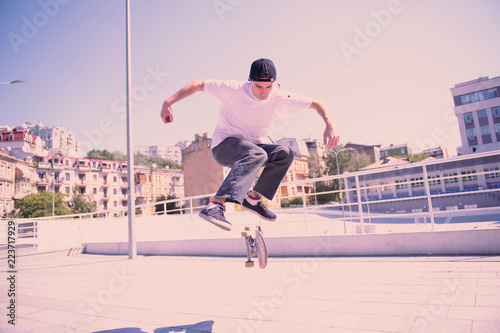 Train your muscles. Serious brunette male jumping while posing on camera