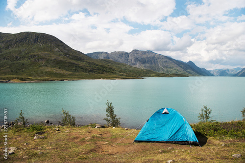 blue tent on Besseggen ridge over Gjende lake in Jotunheimen National Park, Norway