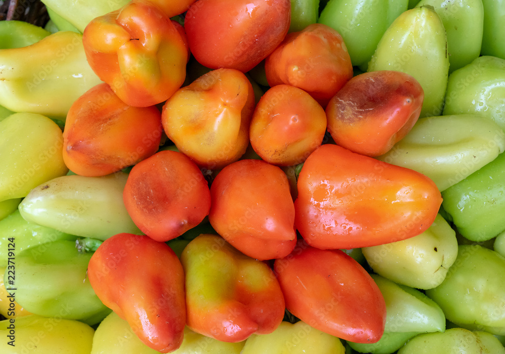 Bulgarian pepper is green and red in the basket. Bulgarian pepper is green and red in the basket.