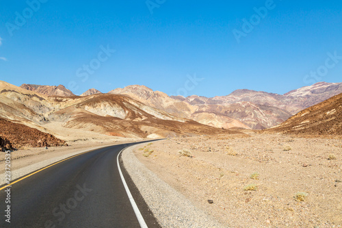Artist's Drive road in Death Valley, with a clear blue sky overhead
