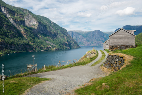 rural road and wooden buildings at Flam village, Aurlandsfjord, (Aurlandsfjorden), Norway