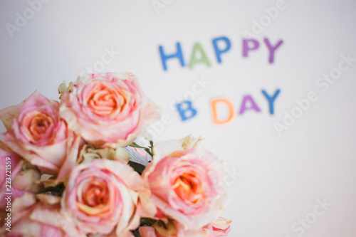 colorful letters happy birthday and roses bouquet. congratulation background
