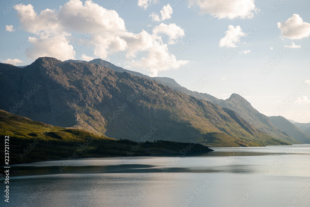 beautiful mountains covered with green vegetation and majestic Gjende lake, Besseggen ridge, Jotunheimen National Park, Norway