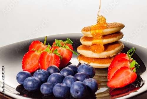 Healthy pancakes with strawberries and blueberries breakfast