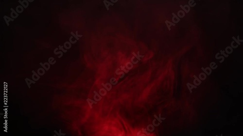 Red smoke on dark background. Smoke curling over a luminous flashlight. Divination over the magical vessel. Beautiful red smoke intro for logo.