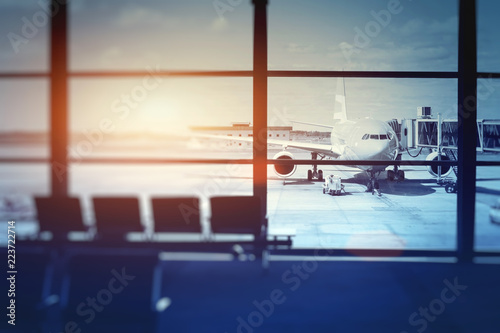 airplane waiting for departure in airport terminal, blurred horizontal background with place for text photo