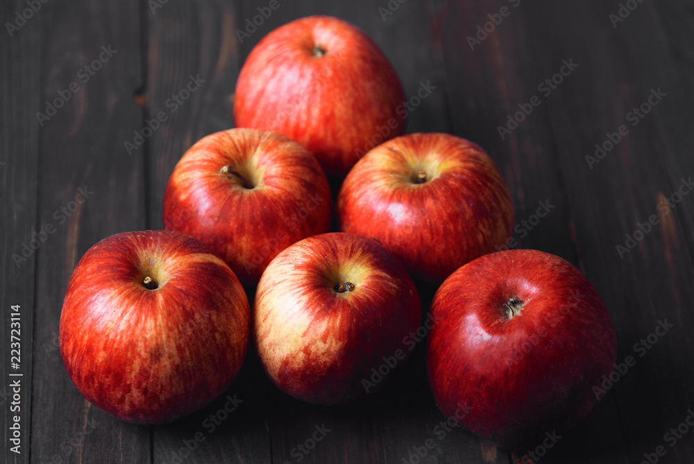 Red apples on a brown wooden background Red apples on a brown wooden background