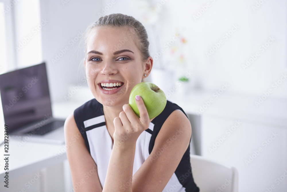 Young beautiful smiling girl with a green apple in hands Young beautiful smiling girl with a green apple in hands