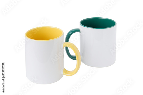 Two white mugs  with a green and yellow handle on a white background.  Isolated.  