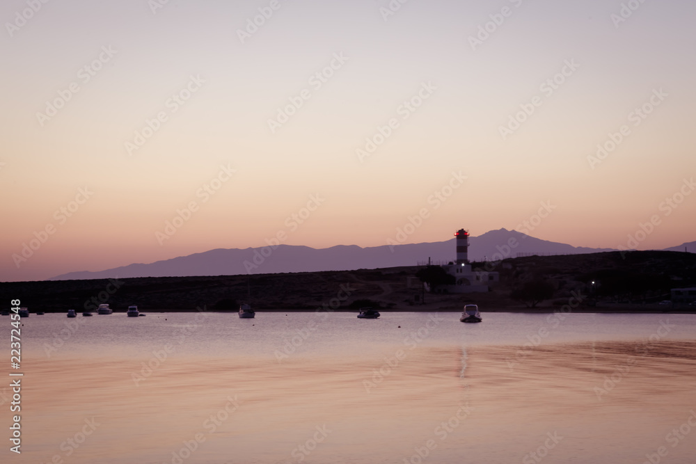 dawn over lighthouse and sea in mediteranean greek cycladic island paros 2