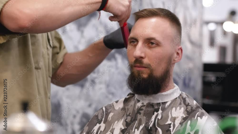 Portrait of a beautiful man with a beard on a haircut Portrait of a beautiful man with a beard on a haircut