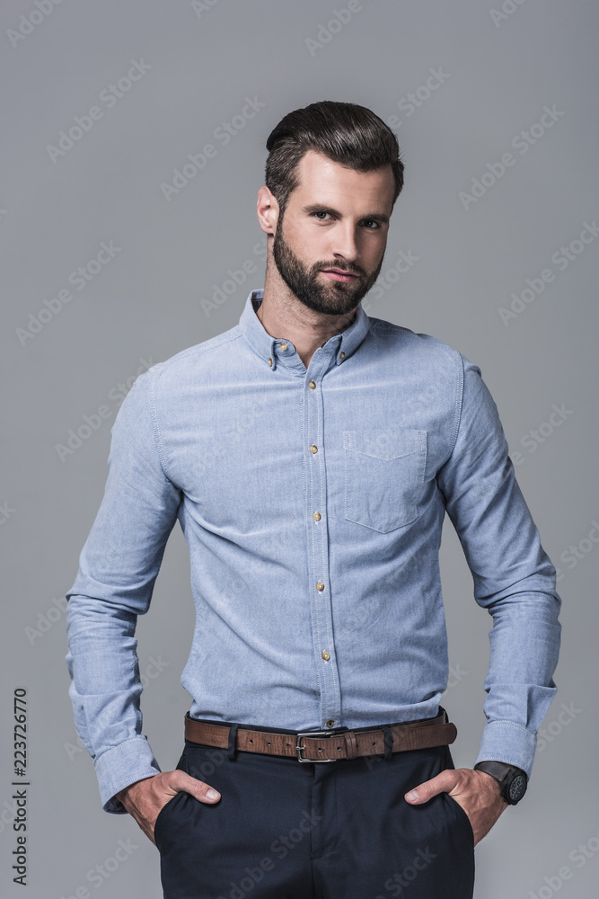 elegant stylish businessman posing in formal wear, isolated on grey elegant stylish businessman posing in formal wear, isolated on grey
