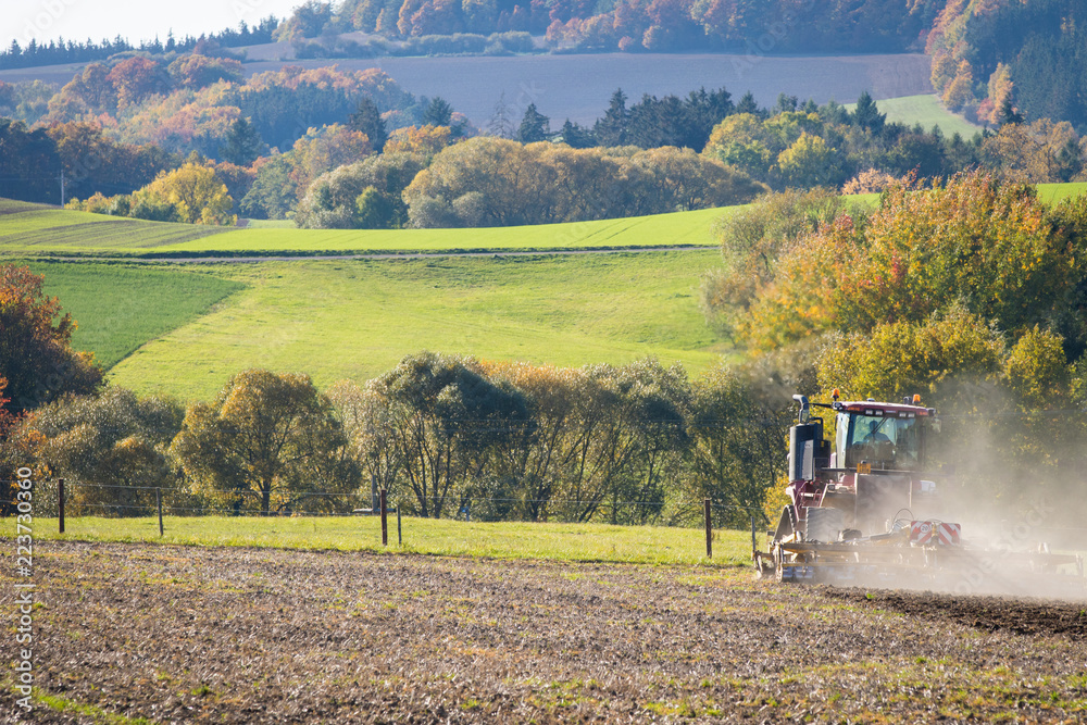 Fototapeta premium Tractor Ploughing on the Field
