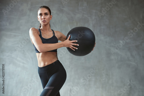 Fototapeta Naklejka Na Ścianę i Meble -  Sports Woman Training In Fashion Black Sportswear