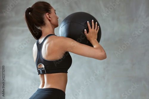 Woman In Fashion Sports Clothes Workout With Med- Ball
