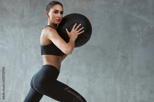 Fototapeta Naklejka Na Ścianę i Meble -  Sports Woman Training In Fashion Black Sportswear