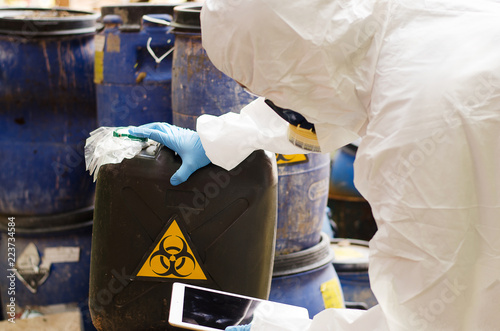 Fotografi Asian scientist wear Chemical protection suit check danger chemical,working at d