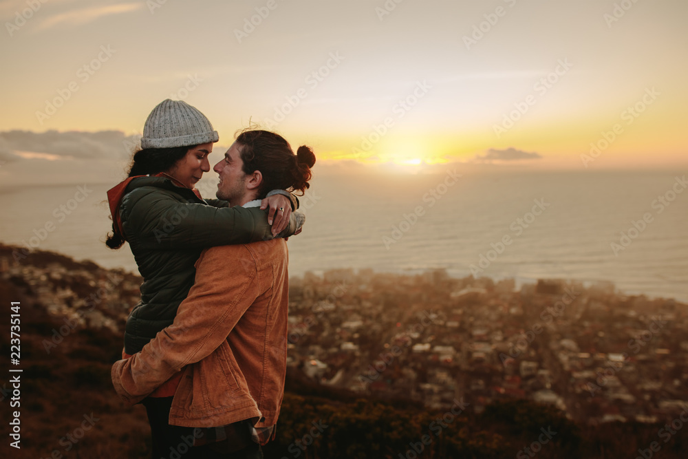 Loving couple at sunset in mountains