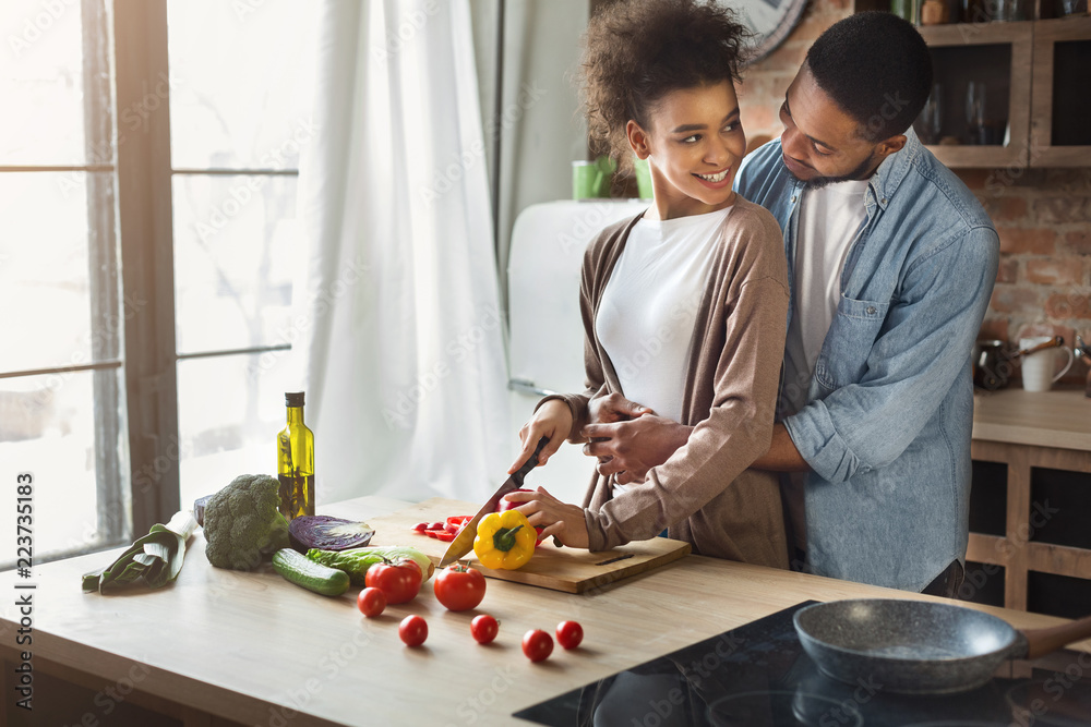 Loving black husband hugging wife while cooking Stock Photo Adobe Stock