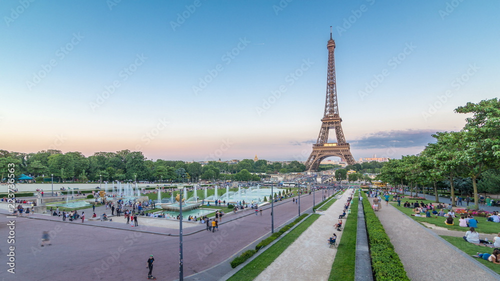 Evening view of Eiffel Tower day to night timelapse with fountain in Jardins du Trocadero in Paris, France. Evening view of Eiffel Tower day to night timelapse with fountain in Jardins du Trocadero in Paris, France.